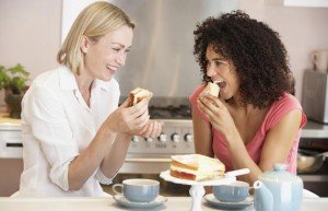 two-happy-women-eating-Masterfile-MonkeyBusinessImages