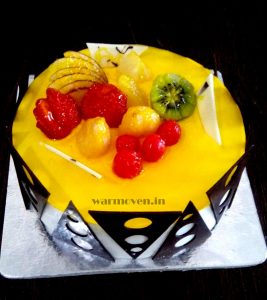 Yellow Holi cake with fruits